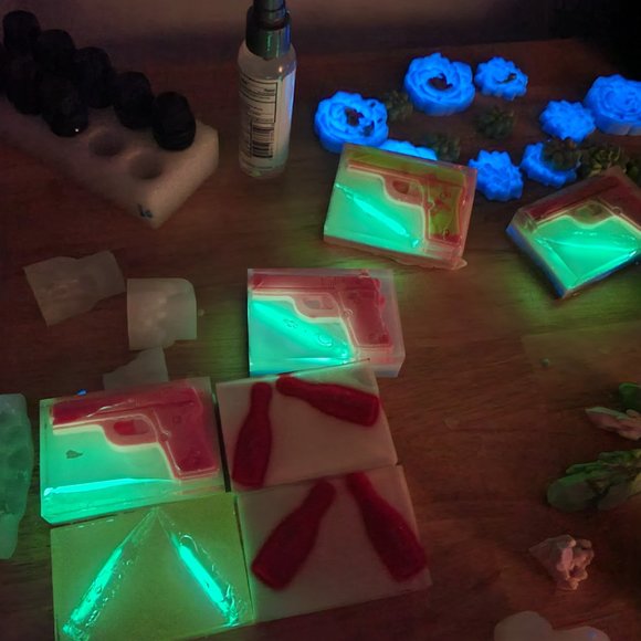 On the left is a pink Shea butter soap gun, under the gun is a clear glow bullet - Picture 3 of 3